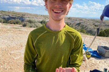 Benjamin Shipley holding a rubber boa near NTC