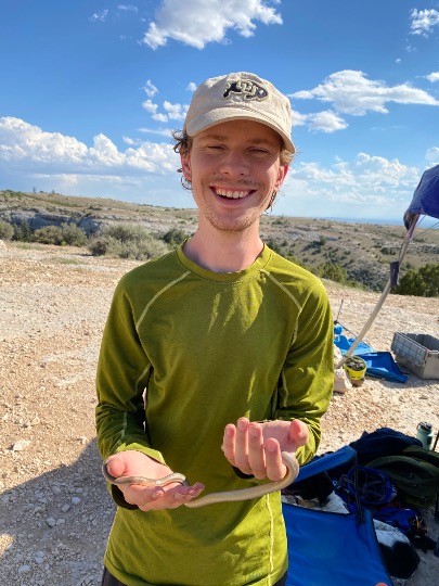 Benjamin Shipley holding a rubber boa near NTC